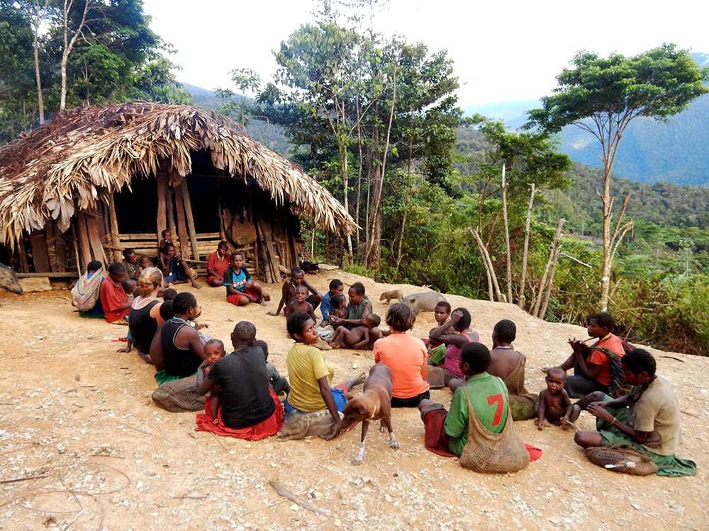 Moi People outside a Hut